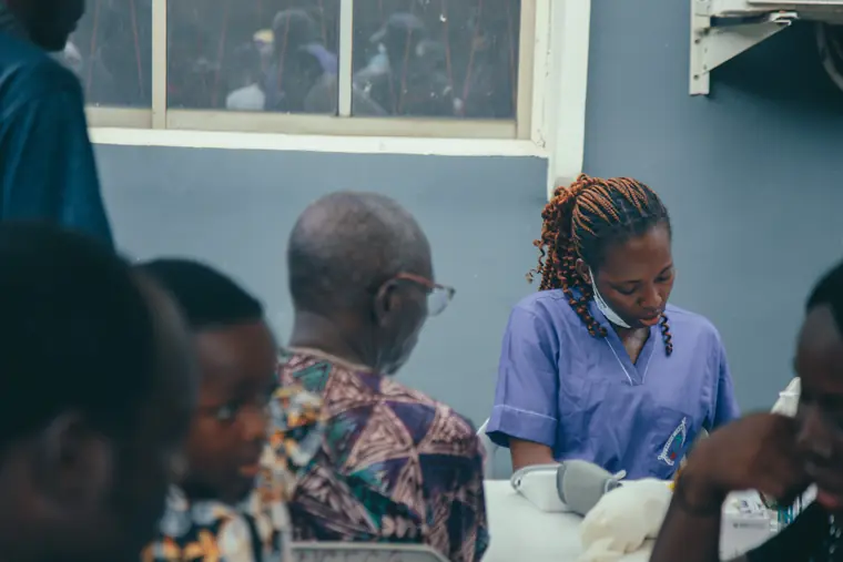 A nurse attends to an elderly man during the screenings.