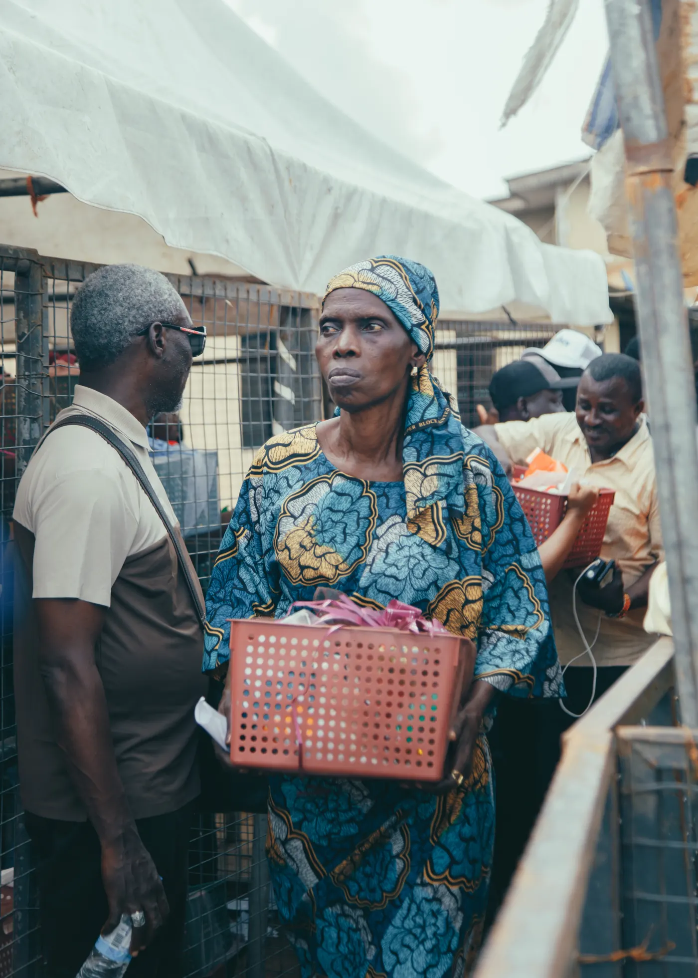 A woman receiving a relief basket at a Smiley Caring Foundation distribution in Lagos.