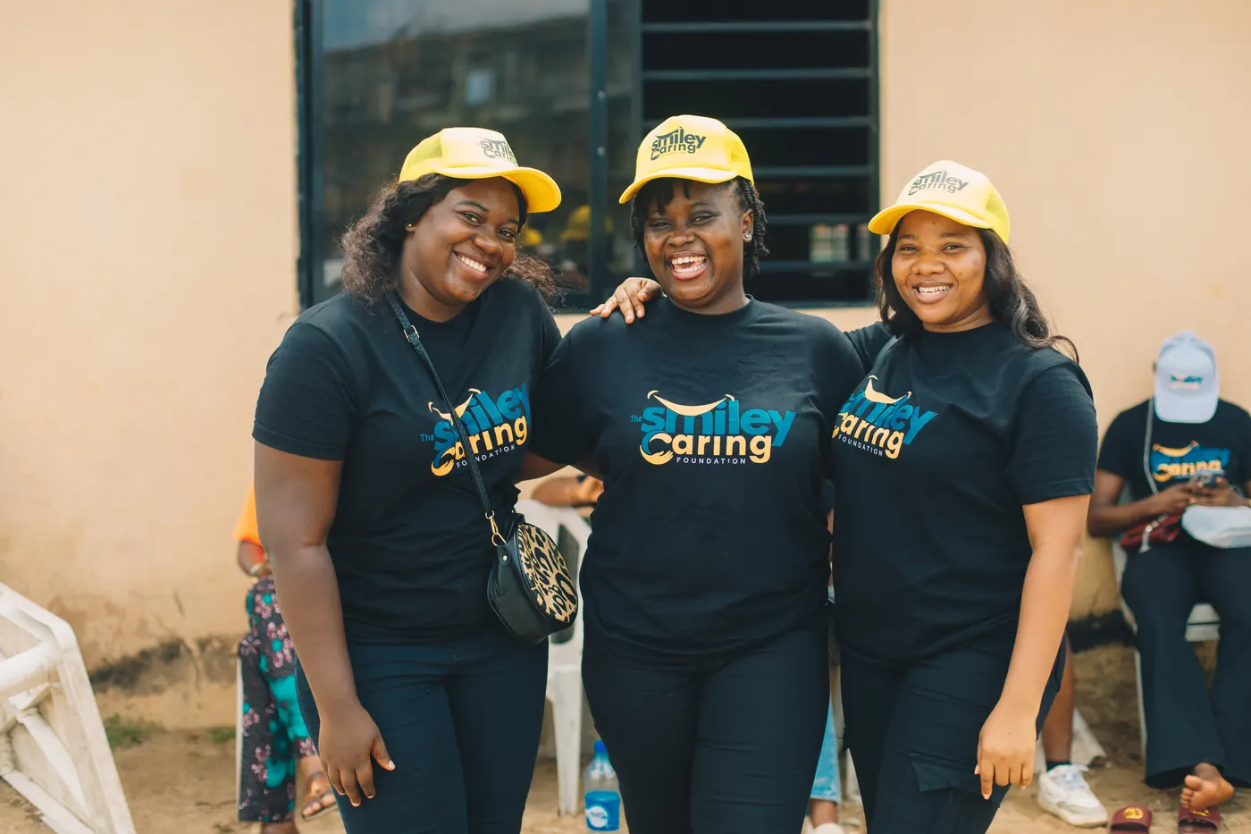 Smiley Caring Foundation volunteers in branded shirts at an outreach.